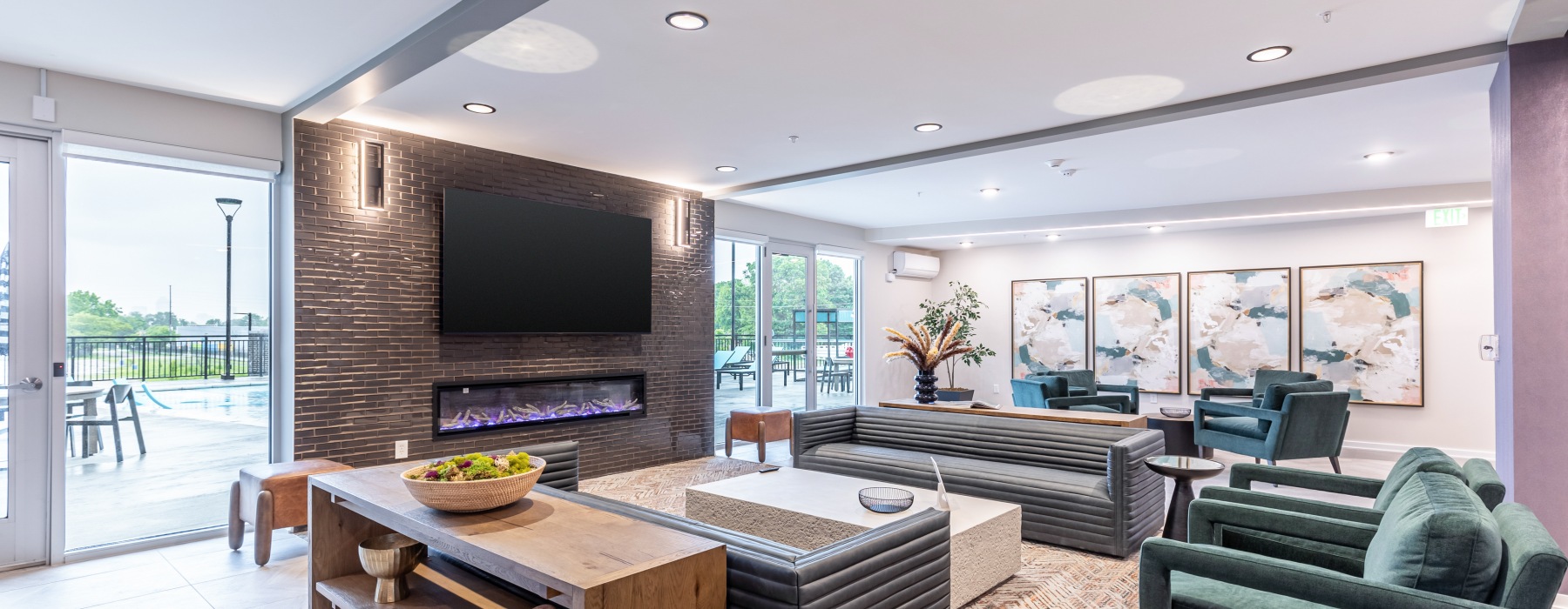 Lounge room with chairs, tv and fireplace