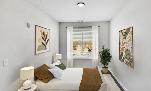 Cornerstone 2 Bed: Bedroom 2 Staged bedroom with curtains and art