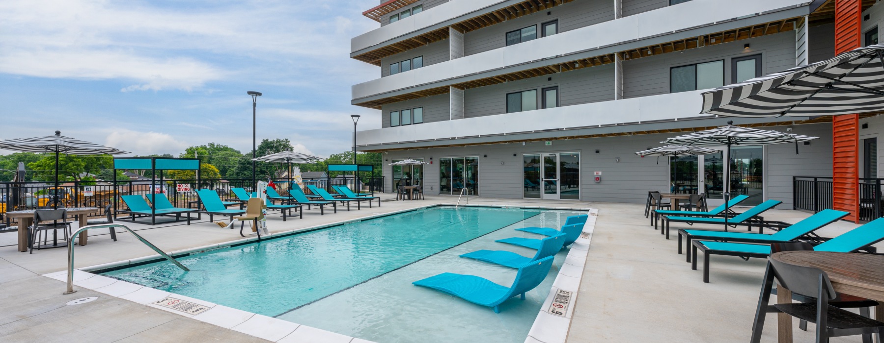 Outdoor pool with blue patio furniture