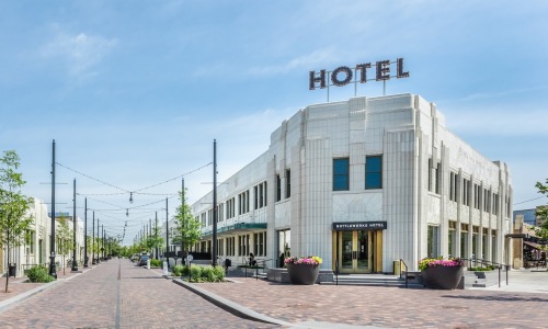 Hotel sign on top of white brick building